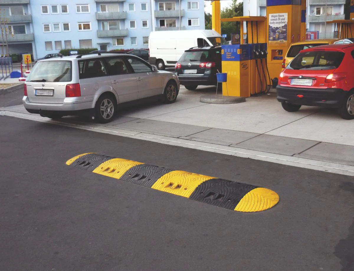 A black and yellow speed ramp on the road.