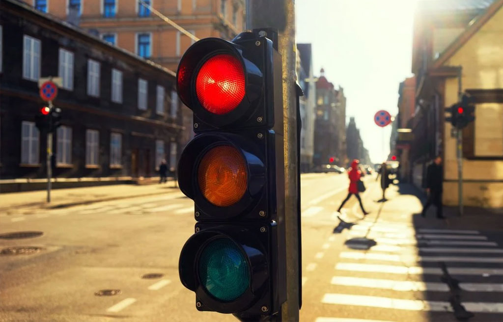 A traffic light next to the crosswalks.