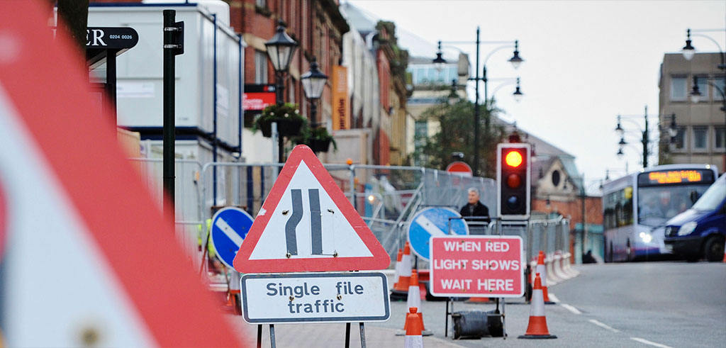 Some traffic signs and traffic cones.