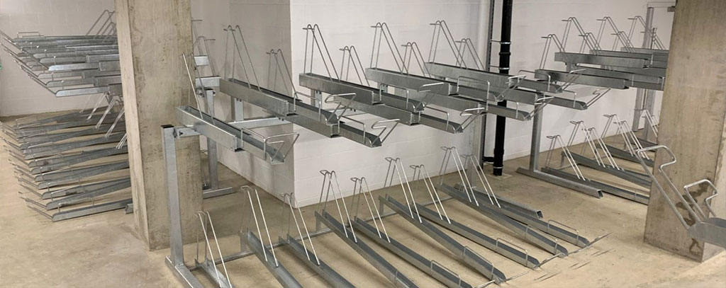 Two-tier racks made of steel for cycle parking, which allow parking multiple bicycles in a single place.