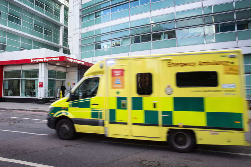 A yellow emergency ambulance outside the emergency department.