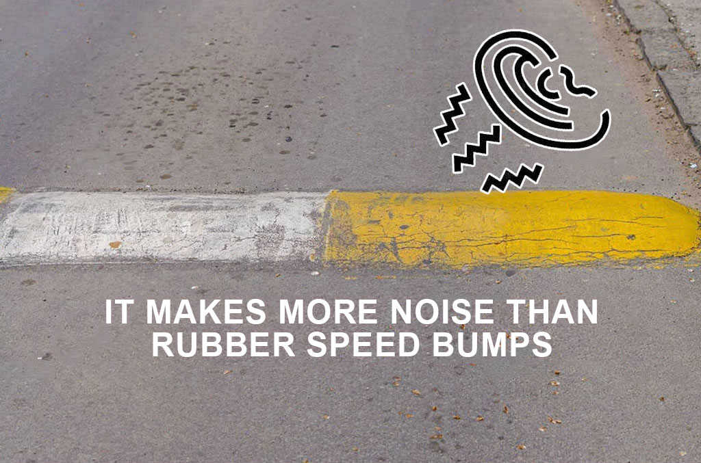 A concrete speed bump were painted yellow and white.